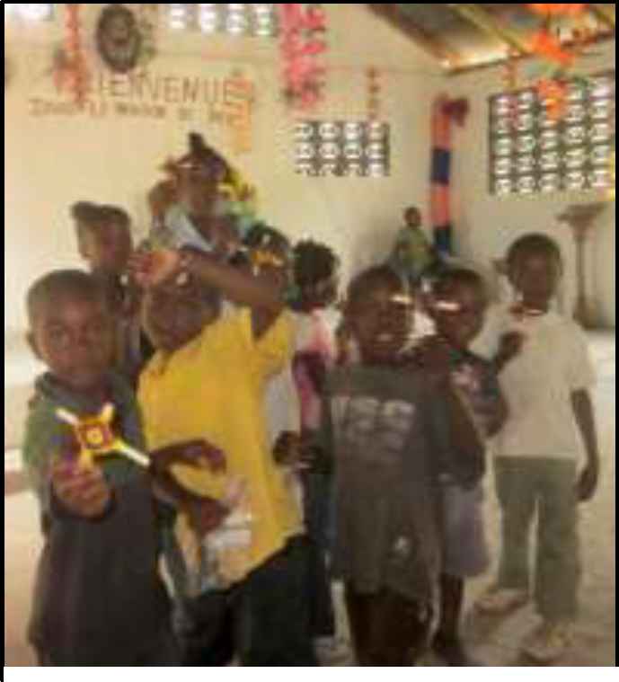 Kids club participants making God’s eyes during a 2012 mission trip
