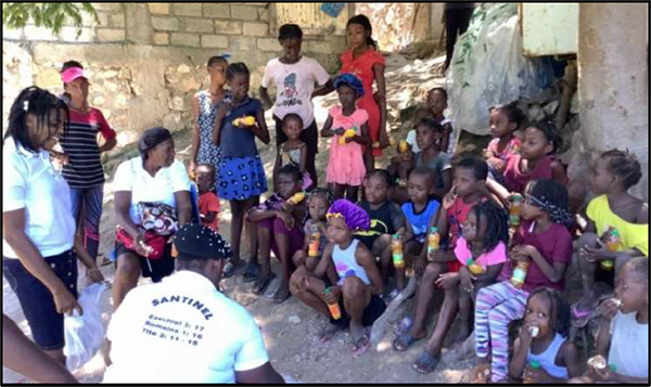 Children in St. Marc wait to receive their food packages