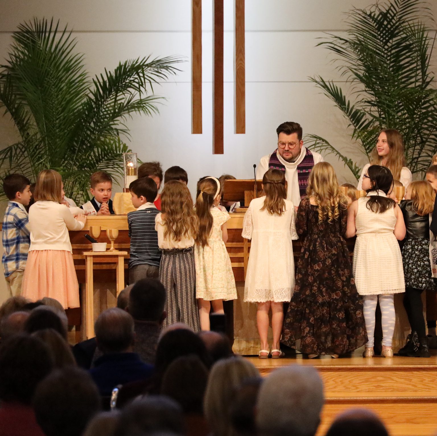 Pastor Matthew speaking to children during church service