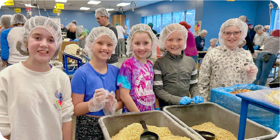 Kids serving food at a charity event